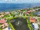 Picturesque aerial view showcasing community pond with fountain, waterfront homes, and lush landscaping at 6107 Marbella Blvd, Apollo Beach, FL 33572