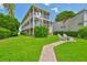 Spacious backyard with a spiral staircase, manicured lawn, and a charming seating area, perfect for outdoor enjoyment at 6107 Marbella Blvd, Apollo Beach, FL 33572