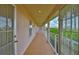 Covered outdoor hallway with consistent roofline, multiple entrances, and views of the neighborhood at 6107 Marbella Blvd, Apollo Beach, FL 33572
