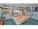 Basement featuring a pool table, bar area, and kitchenette, creating an ideal space for recreation and entertainment at 6107 Marbella Blvd, Apollo Beach, FL 33572