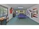 Finished basement featuring a ping pong table and decorative sports memorabilia for versatile recreational opportunities at 6107 Marbella Blvd, Apollo Beach, FL 33572