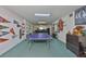 Finished basement with a ping pong table, decorated with sports memorabilia and offering a versatile recreational space at 6107 Marbella Blvd, Apollo Beach, FL 33572