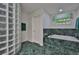 Gorgeous bathroom with green tile, glass block shower, and a relaxing soaking tub at 6107 Marbella Blvd, Apollo Beach, FL 33572