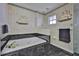 This bathroom features a jacuzzi and decorative wallpaper at 6107 Marbella Blvd, Apollo Beach, FL 33572