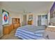 Bedroom offering wood floors, two dressers, stained glass, and attached bathroom at 6107 Marbella Blvd, Apollo Beach, FL 33572