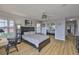 This bedroom features a ceiling fan, a desk, and closet with mirrored doors at 6107 Marbella Blvd, Apollo Beach, FL 33572