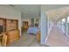 An open doorway leads to a bedroom with wood floors and access to an outdoor hallway at 6107 Marbella Blvd, Apollo Beach, FL 33572