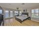 This bedroom features hardwood floors, a desk, and a balcony at 6107 Marbella Blvd, Apollo Beach, FL 33572