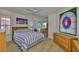 A bedroom with wood floors, two dressers, and a workspace with a chair at 6107 Marbella Blvd, Apollo Beach, FL 33572