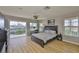 This bedroom features hardwood floors, a desk, and a balcony at 6107 Marbella Blvd, Apollo Beach, FL 33572