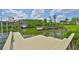 Beautiful waterfront property with a dock, boat lift, and scenic views of the calm waters and surrounding greenery at 6107 Marbella Blvd, Apollo Beach, FL 33572