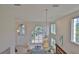 Bright foyer features soaring ceilings, arched windows, tile floors, and an elegant chandelier at 6107 Marbella Blvd, Apollo Beach, FL 33572