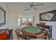 This game room features an octagonal table, ceiling fan, and overlooks an interior balcony at 6107 Marbella Blvd, Apollo Beach, FL 33572