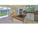 Eat-in kitchen featuring granite countertops, stainless steel appliances, and a view of the canal at 6107 Marbella Blvd, Apollo Beach, FL 33572