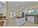 Well-lit kitchen featuring granite counters, white cabinetry, a center island, and stainless steel appliances at 6107 Marbella Blvd, Apollo Beach, FL 33572