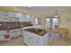 Bright kitchen showcasing granite countertops, white cabinets, modern appliances, and a cozy breakfast nook at 6107 Marbella Blvd, Apollo Beach, FL 33572