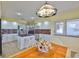 Bright kitchen with white cabinets and granite countertops, a center island, and a view to the stairs at 6107 Marbella Blvd, Apollo Beach, FL 33572
