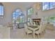 Open-concept living and dining area featuring high ceilings, large windows, a fireplace, and chandelier for upscale living at 6107 Marbella Blvd, Apollo Beach, FL 33572