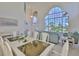 Bright and airy living space with high windows and an adjacent dining area at 6107 Marbella Blvd, Apollo Beach, FL 33572