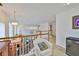 A loft featuring a wet bar, beverage fridge, and a comfortable seating area overlooking the living room at 6107 Marbella Blvd, Apollo Beach, FL 33572