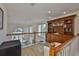 Loft area with bar, wine cooler, and open view of the living space below at 6107 Marbella Blvd, Apollo Beach, FL 33572