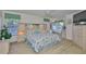 Bright main bedroom with a king bed, views of the backyard, and an en-suite bathroom at 6107 Marbella Blvd, Apollo Beach, FL 33572