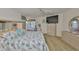 Bright main bedroom with a king bed, TV, and blonde wood furniture at 6107 Marbella Blvd, Apollo Beach, FL 33572