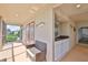 Relaxing screened patio with outdoor kitchen, seating area, and french door access at 6107 Marbella Blvd, Apollo Beach, FL 33572