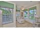 Light and airy sitting room with a chaise lounge and lots of light from the many windows at 6107 Marbella Blvd, Apollo Beach, FL 33572