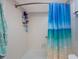 Bathroom featuring a white shower tub and a blue ocean-themed shower curtain at 6161 Gulf Winds Dr # 347, St Pete Beach, FL 33706