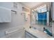 Bright bathroom with a white marble vanity, a decorative mirror, and beach-themed decor at 6161 Gulf Winds Dr # 347, St Pete Beach, FL 33706