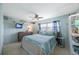 Serene bedroom with coastal-themed decor, TV, and soft blue accents at 6161 Gulf Winds Dr # 347, St Pete Beach, FL 33706