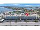 Exterior of complex near the water with a parking area and neatly trimmed palm trees at 6161 Gulf Winds Dr # 347, St Pete Beach, FL 33706