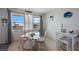 Dining space offering outdoor views with a round glass table and four wicker chairs at 6161 Gulf Winds Dr # 347, St Pete Beach, FL 33706