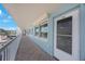 Hallway showing unit entrance, tile floors and patio railing, with scenic outdoor views at 6161 Gulf Winds Dr # 347, St Pete Beach, FL 33706
