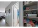 Bright hallway with storage shelves and view of living room and bath at 6161 Gulf Winds Dr # 347, St Pete Beach, FL 33706