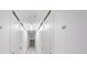 Storage hallway featuring numbered white doors and overhead lighting at 6161 Gulf Winds Dr # 347, St Pete Beach, FL 33706