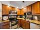 Modern kitchen with stainless steel oven, microwave, and mosaic backsplash at 6161 Gulf Winds Dr # 347, St Pete Beach, FL 33706