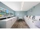 Laundry room featuring several rows of washing machines and large windows at 6161 Gulf Winds Dr # 347, St Pete Beach, FL 33706