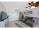 Open living area featuring a sectional sofa, beach decor and nearby dining space at 6161 Gulf Winds Dr # 347, St Pete Beach, FL 33706