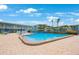 Community swimming pool surrounded by lounge chairs and well-maintained landscaping at 6161 Gulf Winds Dr # 347, St Pete Beach, FL 33706