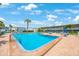 Large community pool surrounded by chairs and umbrellas, set against the backdrop of condos at 6161 Gulf Winds Dr # 347, St Pete Beach, FL 33706