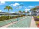 Shuffleboard courts surrounded by palm trees, building, and pool at 6161 Gulf Winds Dr # 347, St Pete Beach, FL 33706