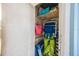 Storage closet containing beach chairs, bags, and additional items on shelves at 6161 Gulf Winds Dr # 347, St Pete Beach, FL 33706