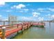 Wooden boardwalk surrounded by water and buildings on a clear, sunny day at 6161 Gulf Winds Dr # 347, St Pete Beach, FL 33706