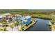 Aerial view showcases a home with waterside access, surrounded by mature landscaping at 6186 Seaside Dr, New Port Richey, FL 34652