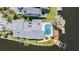 Aerial view shows the pool and dock area, surrounded by waterway and mature landscaping at 6186 Seaside Dr, New Port Richey, FL 34652