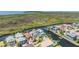Aerial view of waterfront homes with canals, lush greenery, and access to the open water at 6186 Seaside Dr, New Port Richey, FL 34652