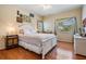 Comfortable bedroom featuring hardwood floors, two windows, and decorative wall art at 6186 Seaside Dr, New Port Richey, FL 34652