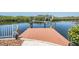 View of boat dock, with boat lift, creating an inviting space for waterfront activities at 6186 Seaside Dr, New Port Richey, FL 34652
